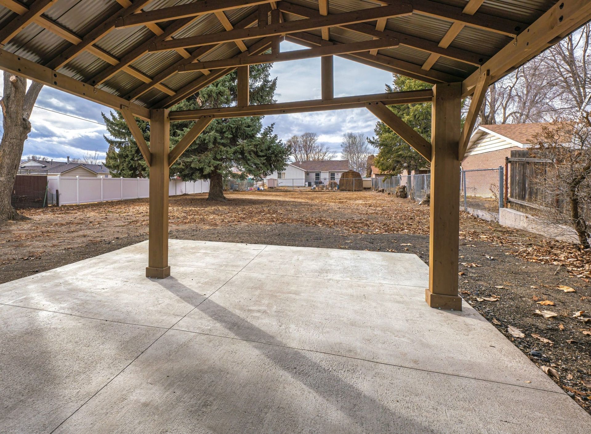 Metal carport installation shading a residential driveway in North Texas