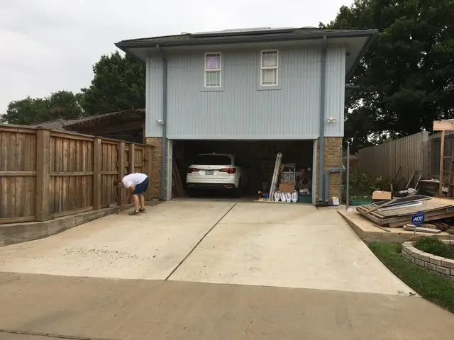 Driveway leading to a two-story garage structure with covered parking below