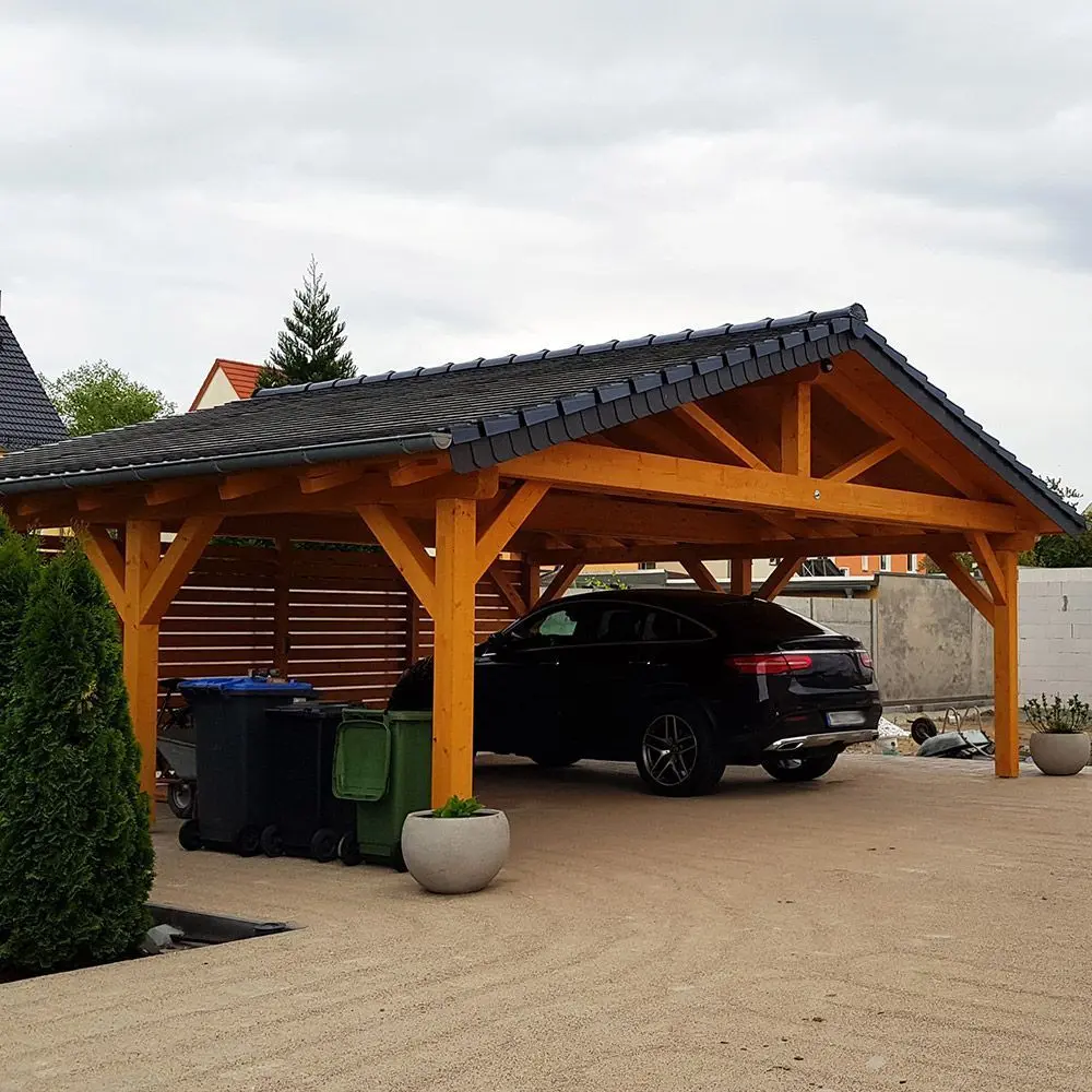 Timber-frame gable carport with a dark metal roof sheltering an SUV