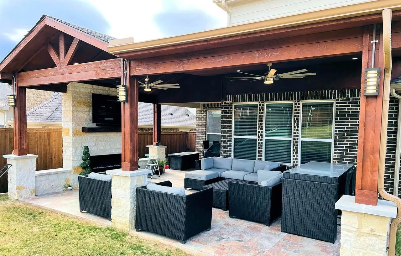 Cedar patio cover with ceiling fans over a paver patio and outdoor sectional
