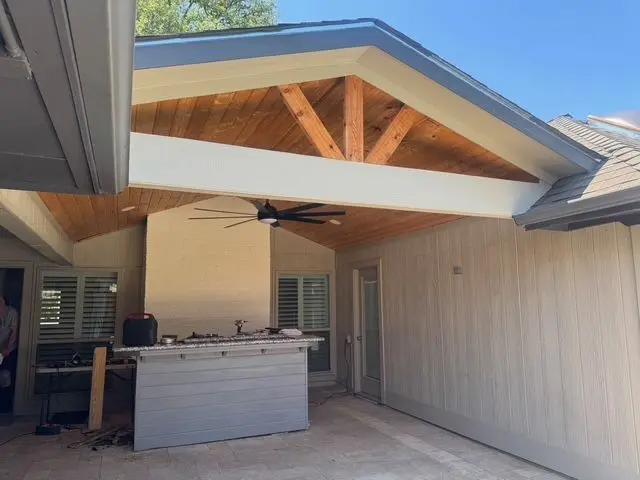 Gable patio cover with cedar trusses over an outdoor kitchen bar