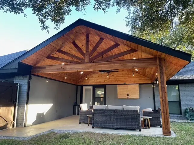 Large sunburst gable patio cover with recessed lighting and dark trim