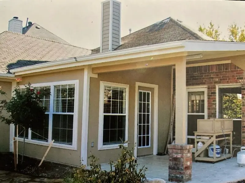 Enclosed patio sunroom with double-hung windows and a glass door