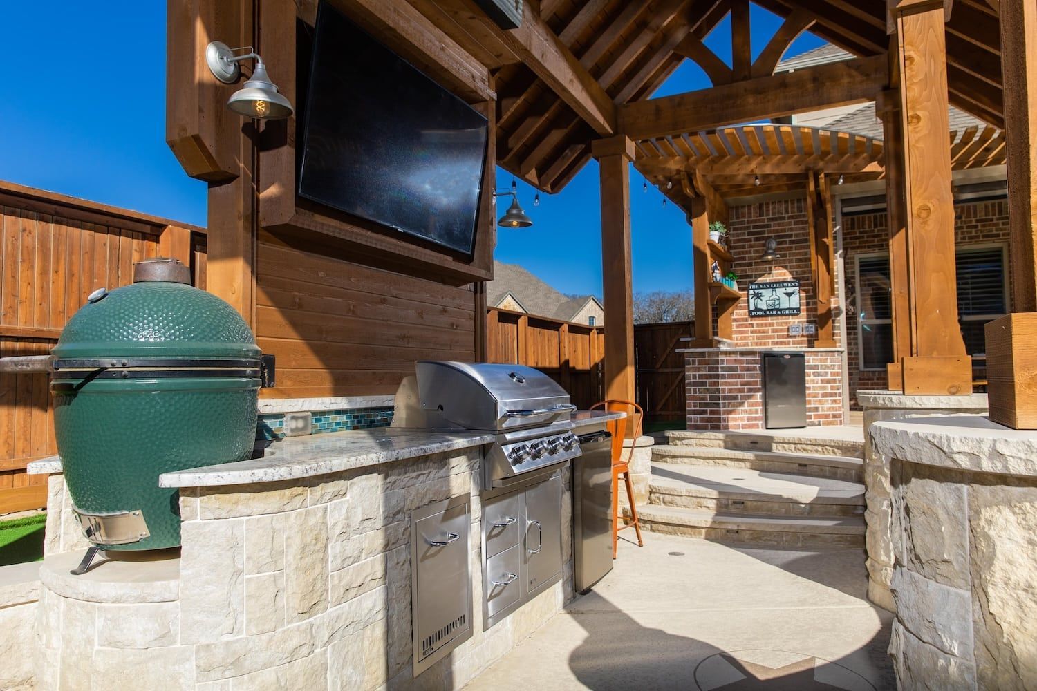 Covered patio with dry bar and outdoor kitchen designed for North Texas summers